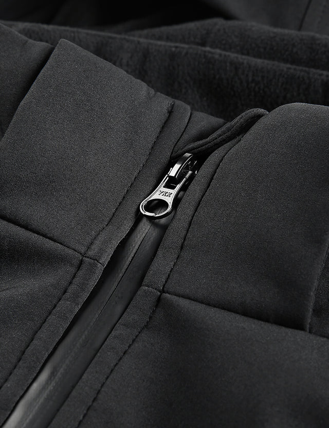 Close-up image focusing on the zipper detail of the black heated jacket, emphasizing quality craftsmanship.