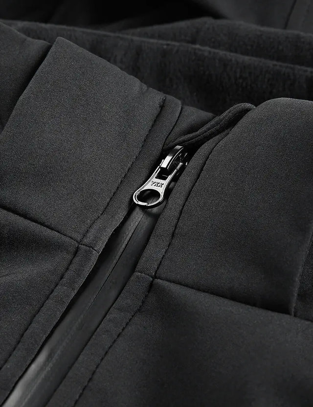 Close-up image of YKK zipper detail on a men's heated jacket, indicating durability and ease of use.