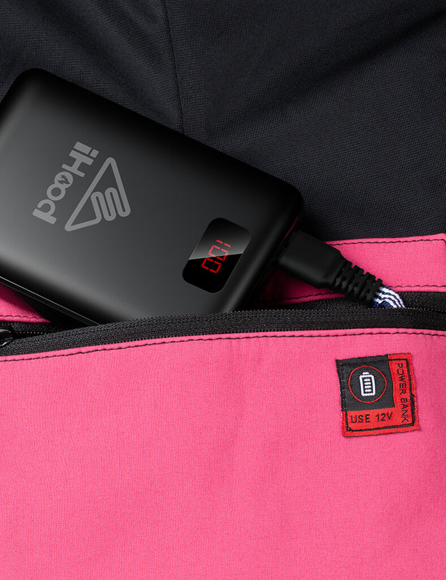 Close-up of the pockets on the pink women's heated jacket, designed for battery storage.