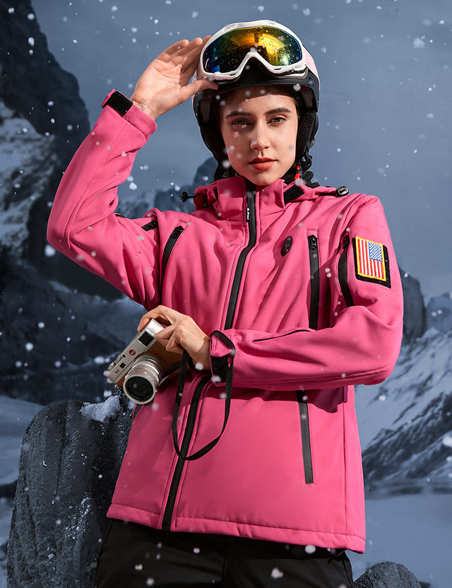 Model skiing outdoors in a pink heated jacket, demonstrating warmth and functionality.