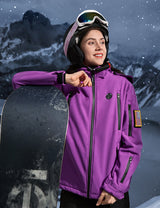 Model demonstrating a purple women's heated jacket while skiing, emphasizing warmth and performance.